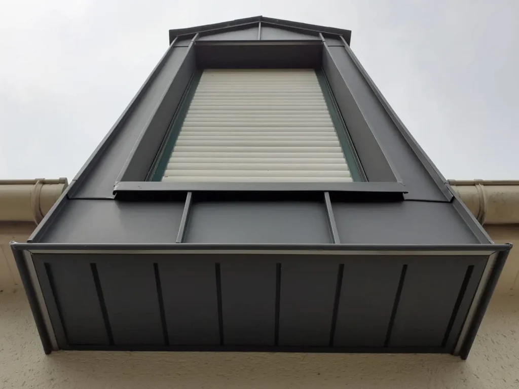 Rénovation toiture avec habillage de lucarne en aluminium par notre artisan couvreur sur un toit ardoise